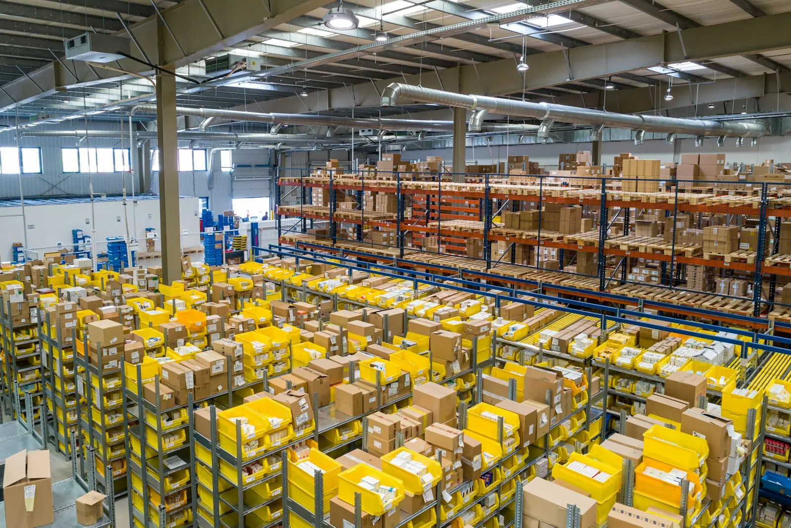 Large fulfillment warehouse with shelves of parcels and packing bins