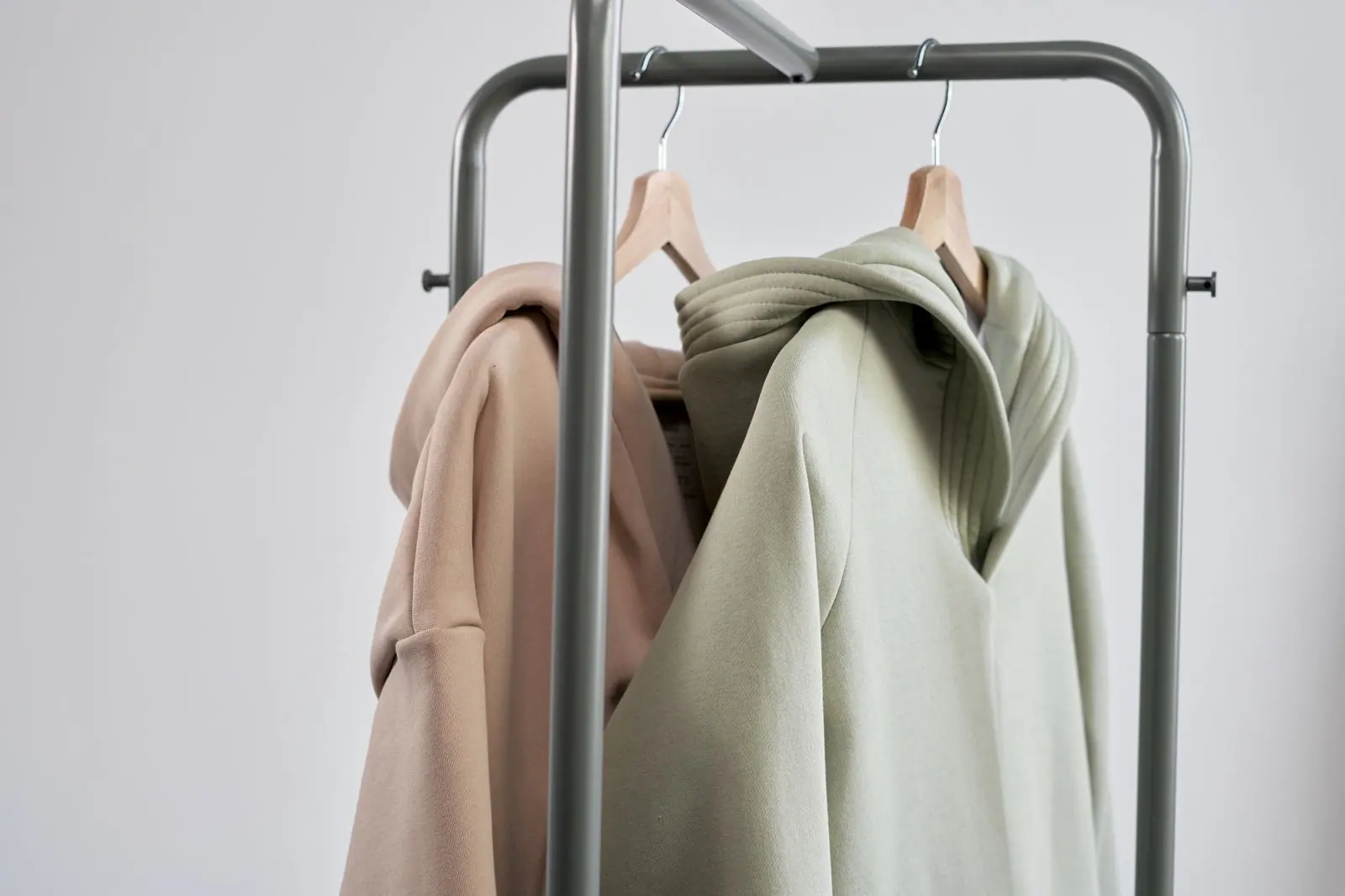 Representative heavyweight blank hoodies on wooden hangers
