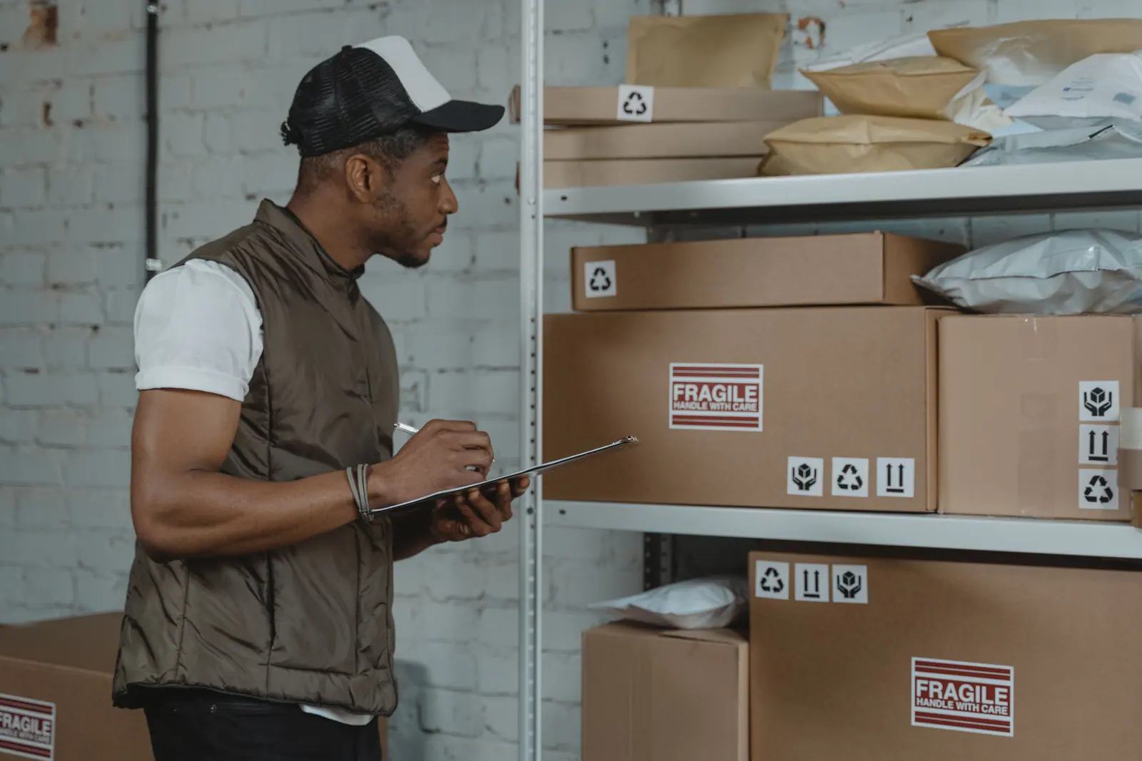 Warehouse worker checking cartons and delivery packages