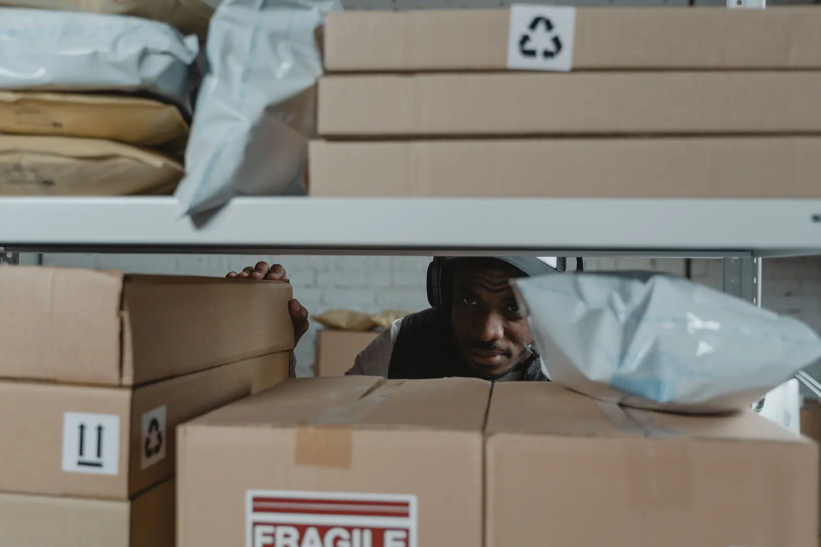 Warehouse worker inspecting supplier parcels before shipment