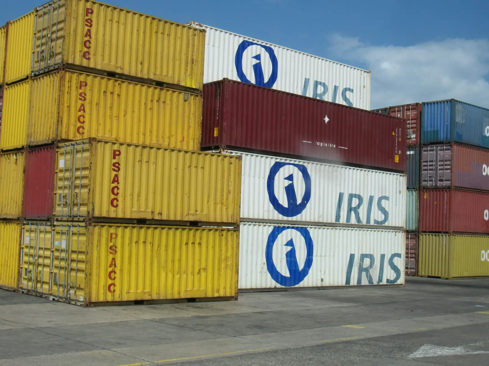 Stacked shipping containers representing international sourcing costs