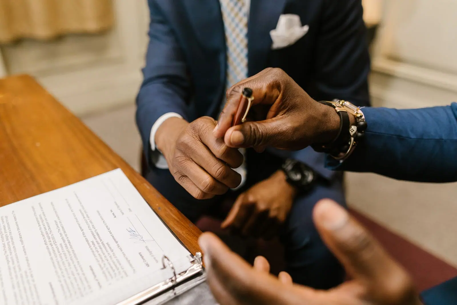 Representative hands reviewing a supplier contract before signature